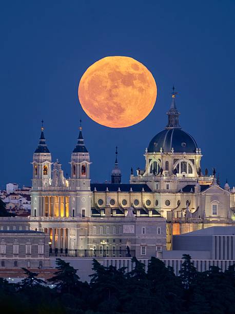 istock Full Moon Rising Behind an Illuminated Cathedral at Twilight 2241070473