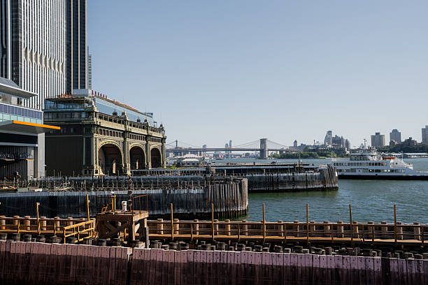 New york city waterfront showing historic pier 17 building, east river, brooklyn bridge, and manhattan skyline