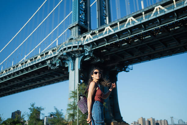 istock Woman exploring new york city under manhattan bridge 2241073359