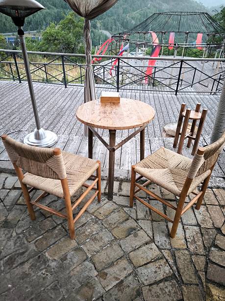 istock A cozy table with wicker chairs on a cafe terrace with mountains in the background 2241073537