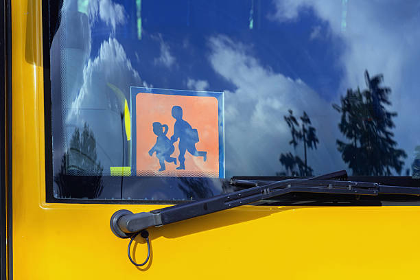 small stop sign as foreground and toy school bus as background