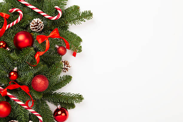 Christmas tree branches with festive decoration on color background, top view