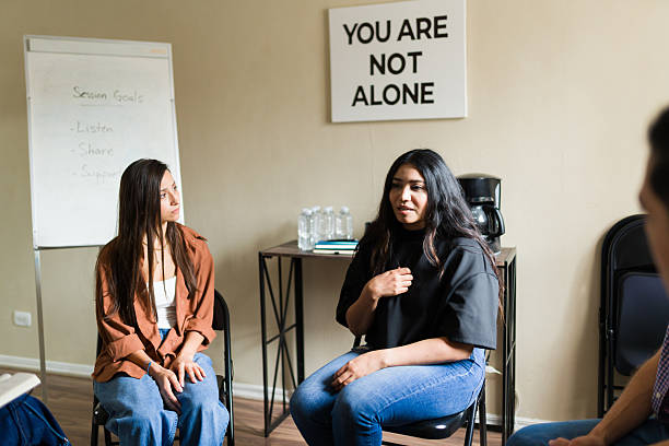 istock Woman sharing experience in mental health support group 2241075407