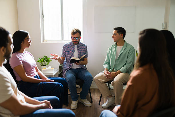 istock People attending group therapy for mental health support 2241075579