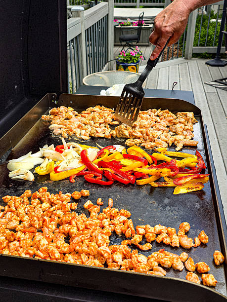 istock Sizzling Chicken and Shrimp on a Flat Top Grill 2241075606