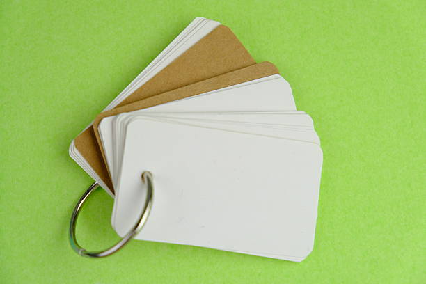Post its notes held by an orange paper clip on blue background. Horizontal composition with copy space. Reminder concept.