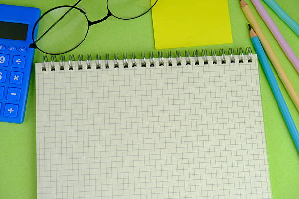 istock blank paper next to school tools with no word as a template for text space concept. business and education concept 2241080778