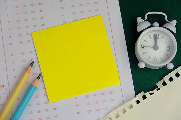 Close-up of yellow sticky note with the word Time written in black marker on whiteboard. Office planning, productivity