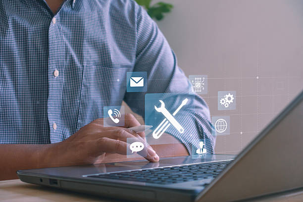 istock Businessman using laptop with digital icons of communication, technology tools and online technical support, IT service, customer assistance and digital business solutions in modern office. 2241084860