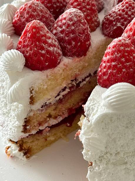 istock Strawberry cake with soft fluffy layers, topped with fresh strawberries and smooth cream, showcasing vibrant red fruit, delicate textures, and sweet inviting appearance in close-up detail 2241086139