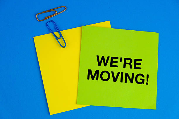 we're moving. text on green paper near on blue background