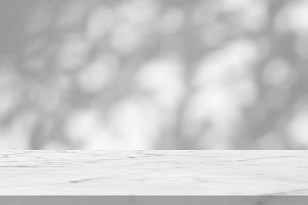 istock Marble table with tree shadow drop on white wall background for mockup product display 2241089794