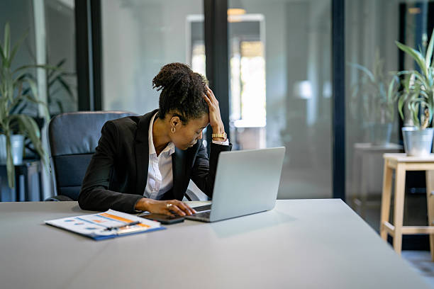 istock Stressed businesswoman suffering headache at work using laptop 2241089904