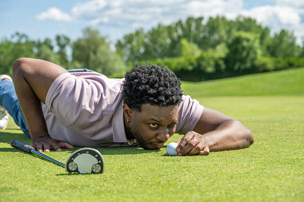 Young golfer using the driver golf club to start the hole