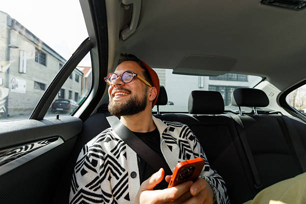 istock Man Having Video Call in Car Backseat 2241096118