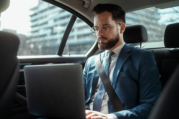 istock Businessman Working on Laptop in Car 2241096120