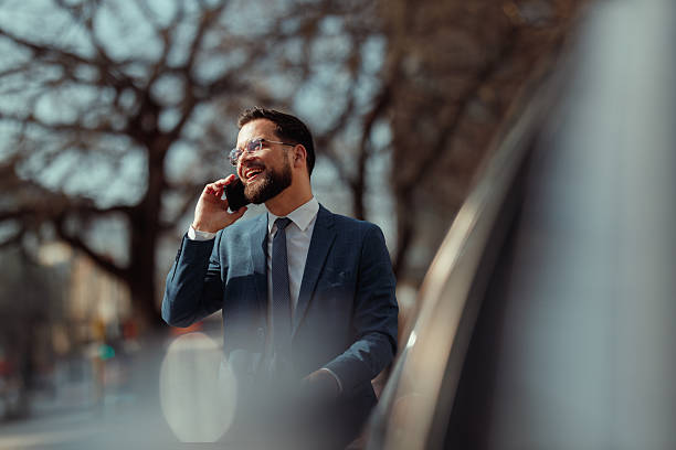 istock Businessman Talking on Phone by Car 2241096131