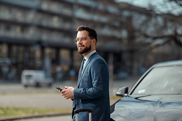 istock Smiling Businessman Using Smartphone Outdoors 2241096135