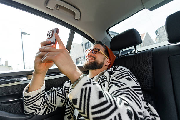 istock Man Having Video Call in Car Backseat 2241096141