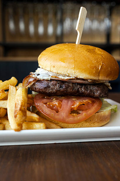 istock Gourmet burger with bacon, egg, and fries 2241102477