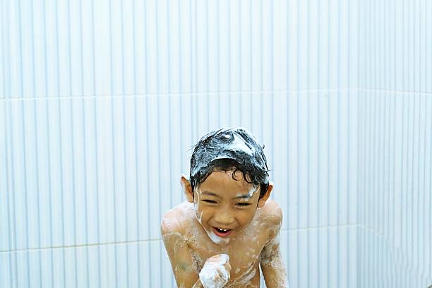 istock Playful boy covered in soap foam during bath 2241104560