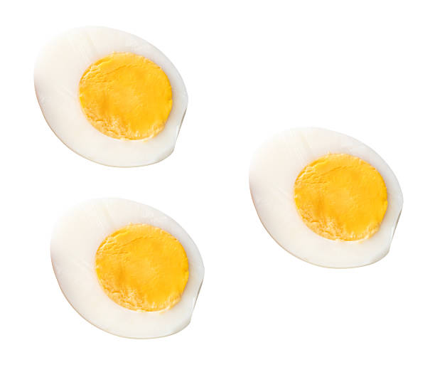 istock Top view set of unpeeled cooked or boiled chicken eggs in three halves with egg yolks isolated on white background with clipping path 2241109032