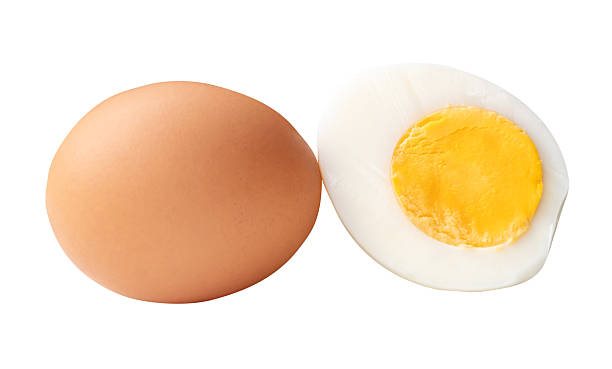 istock Top view of one raw brown chicken eggs and one boiled or cooked eggs in a half with egg yolk isolated on white background with clipping path 2241109078