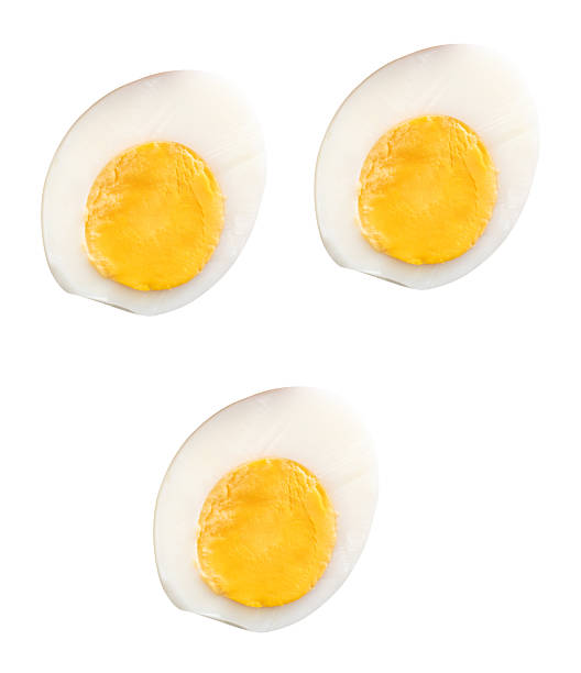 istock Top view set of unpeeled cooked or boiled chicken eggs in three halves with egg yolks isolated on white background with clipping path 2241109085