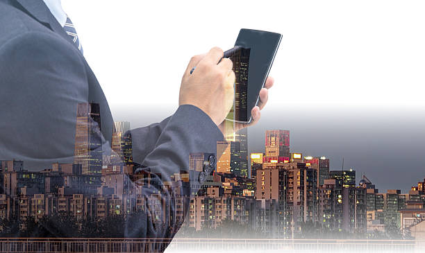 istock Double exposure of a businessman using a device, blended with a dynamic Hong Kong city view. Modern urban architecture and buildings in China. 2241109877