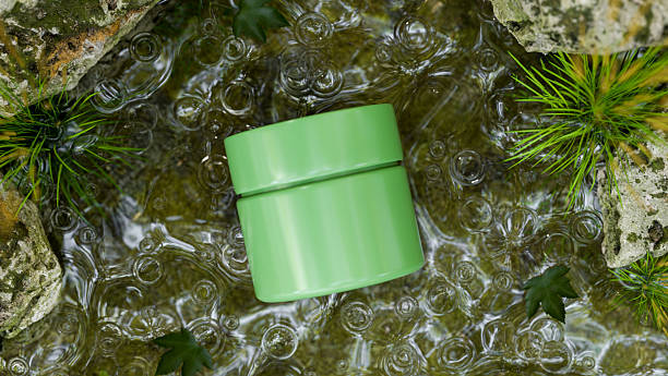 istock Green cream jar container mockup organic natural ingredient in water stream aside moss covered rock. 2241110699