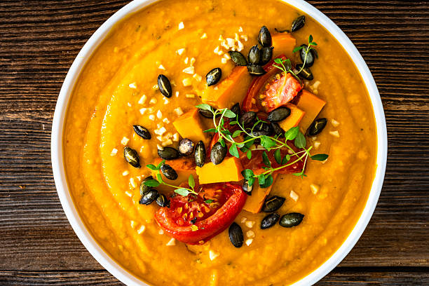 istock Pumpkin cream soup on wooden table 2241114005