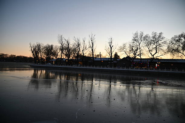 Beijing, China - December 19 2023: The Scenery of Beijing During Winter. Photo showing the gardens near the Forbidden City of Beijing, with snow spreading all over the ground against ancient red buildings of China