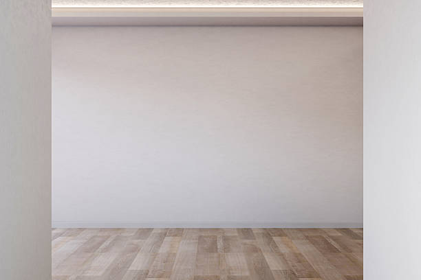 istock Empty room with white wall and ceiling lighting over wooden parquet floor in modern gallery showroom 2241114598