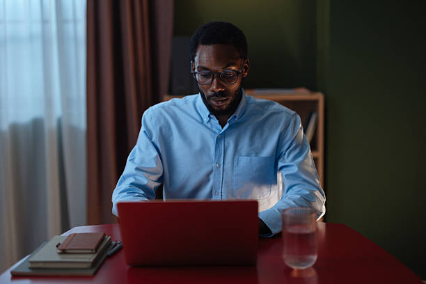 istock Young black man working on laptop at home office 2241118263