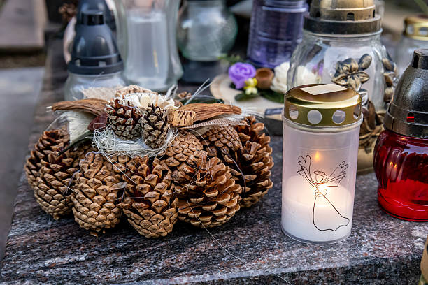 istock pine cone wreath and cemetery candle with angel illustration 2241120333