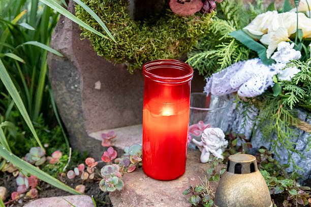 istock Red cemetery candle on gravestone 2241120587