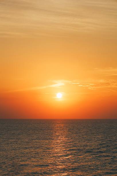 istock Golden Sunset Over Calm Ocean With Bright Sun Reflections On The Horizon 2241122374