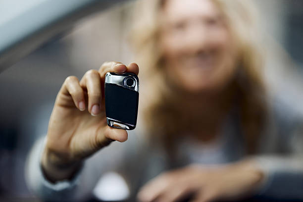 A detailed view of a car key remote featuring lock and unlock buttons, illustrating the convenience and modern technology within automotive security. Ideal for automotive industry, security features, and technology enthusiasts.