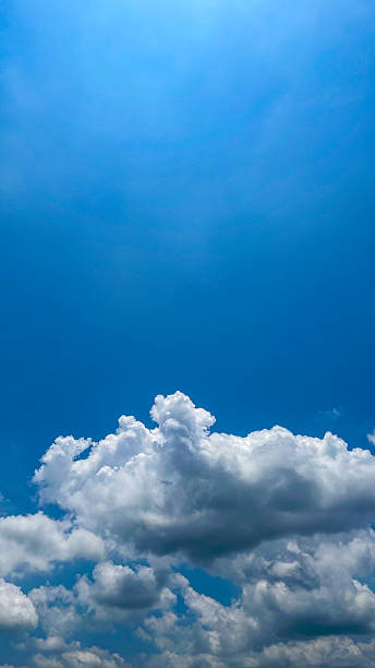 istock Beautiful blue sky with white clouds on a bright sunny day. Natural atmosferis background perfect for weather themes, relaxation concepts, or environmental designs. 2241126953