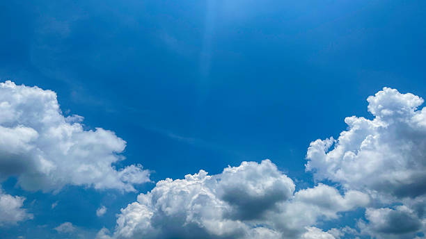 istock Beautiful blue sky with white clouds on a bright sunny day. Natural atmosferis background perfect for weather themes, relaxation concepts, or environmental designs. 2241126956