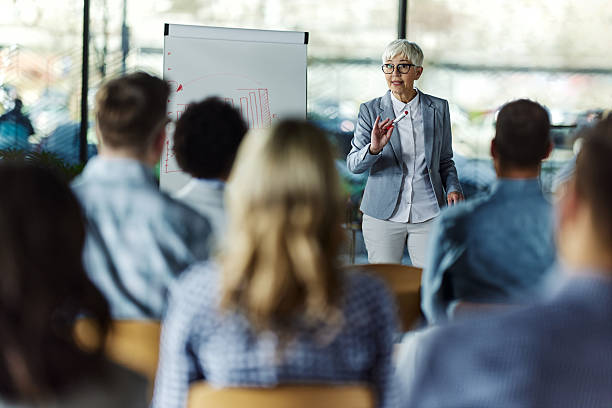 istock Senior female leader talking on presentation in the office. 2241127554