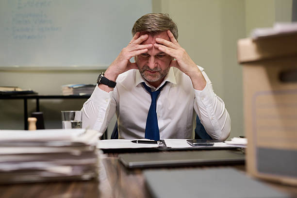 istock Middle Aged Caucasian Man Sitting at Desk Experiencing Work Related Stress 2241127587