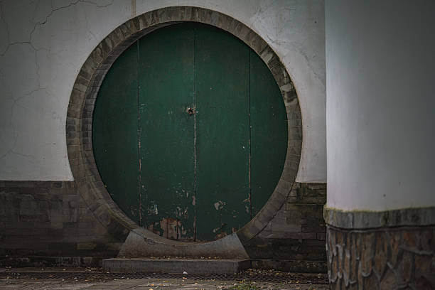 China, Beijing - September 22, 2025 : An ancient building with details is shown. A circular green door is set into the structure, possibly the Summer Palace. The design focuses on architectural aspects.