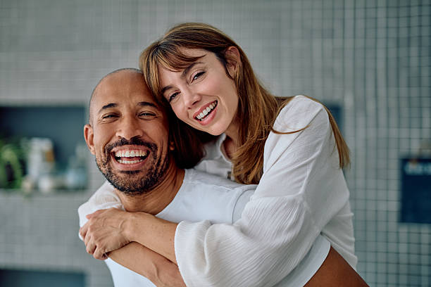 istock Happy diverse couple having fun piggybacking indoors 2241129817