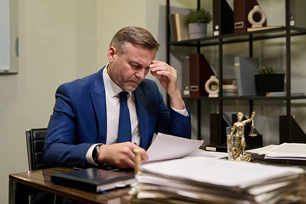 istock Middle Aged Caucasian Man Reading Documents and Thinking at Office Desk 2241130823