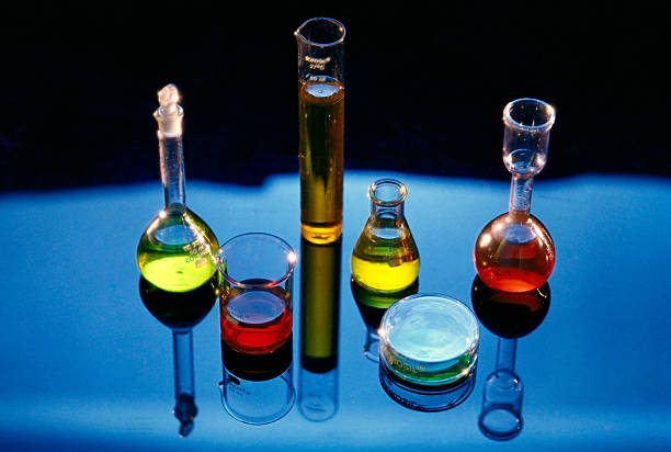 colorful chemicals, glass beakers, blue background