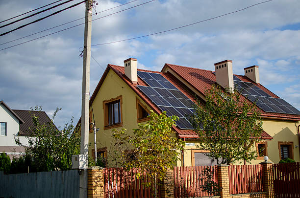 istock Modern house with red-tiled roof and solar panels 2241133107