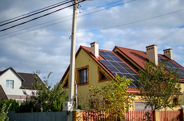 istock Modern house with red-tiled roof and solar panels 2241133130