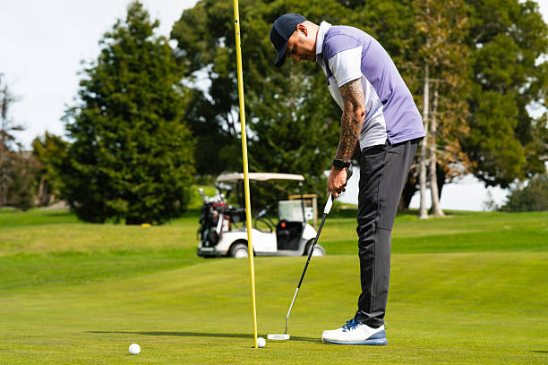 istock Golfer's careful putt moves steadily toward the hole. 2241136285
