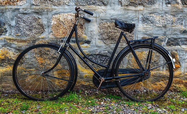 istock Vintage Bicycle Leaning against a Stone Wall 2241142849
